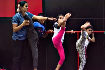 Gymnastic Coach giving instruction to beginners